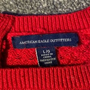 American Eagle Outfitters…Red sweater with zipper on back of neck, size large,
